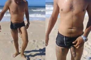 Macho mostrando a rola mole na praia